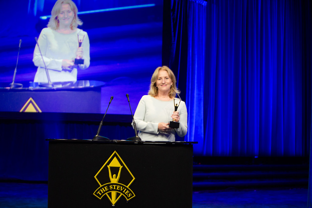 This is an image of Executive Director Kris Hoellen receiving the Stevie Awards at a reception in New York City.